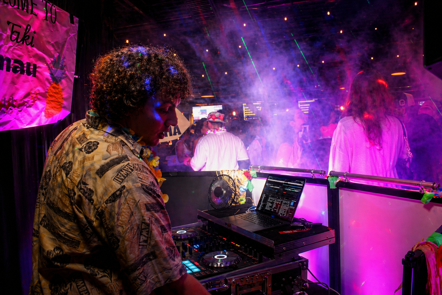 DJ Laki performing at a tropical-themed event with vibrant purple lighting, smoke effects, and crowd energy &ndash; Atlanta Music Pros