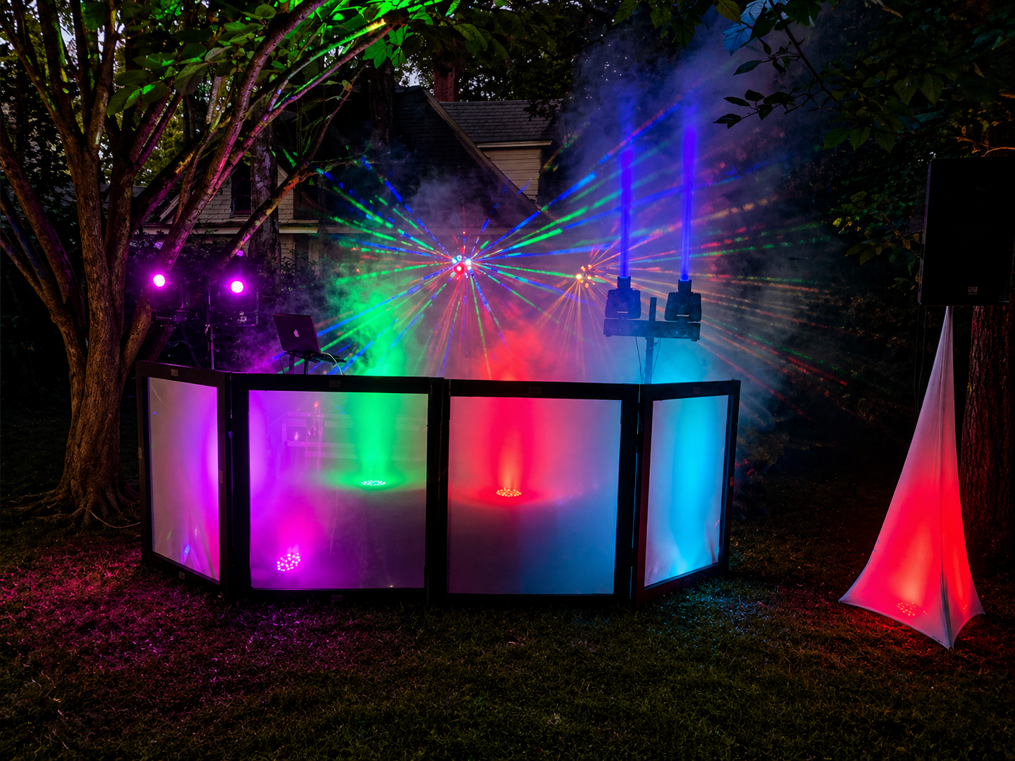 Atlanta Music Pros illuminated DJ booth with multicolor lasers and fog at an outdoor evening event