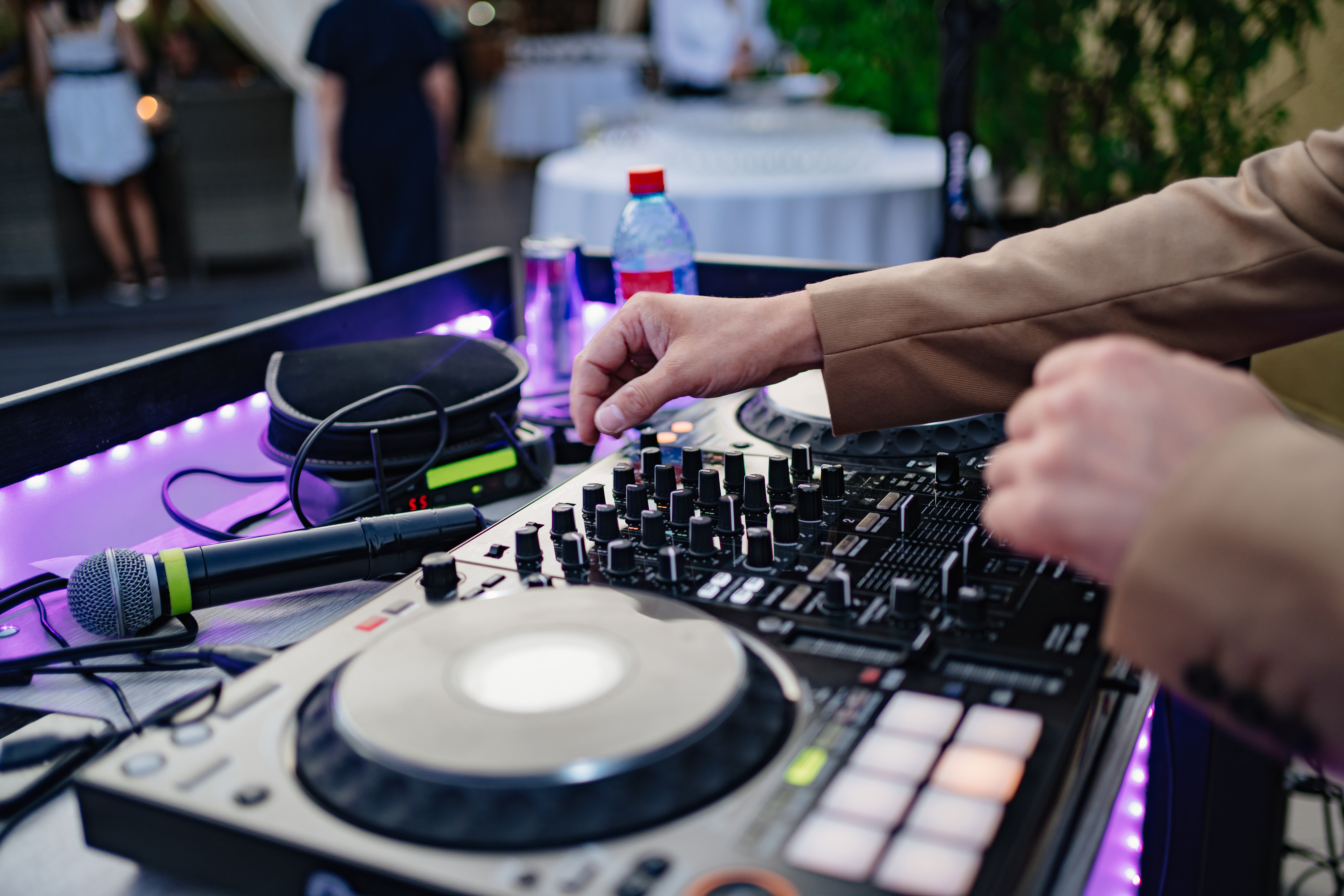 Professional DJ mixing live on a controller at an Atlanta event